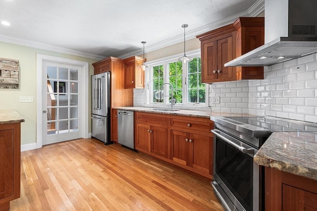 6 Fruit St, Hopkinton, MA 01748 - kitchen with stainless steel appliances, wall chimney exhaust hood, brown cabinetry, decorative backsplash, and crown molding