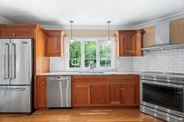 6 Fruit St, Hopkinton, MA 01748 - kitchen with stainless steel appliances, wall chimney range hood, brown cabinets, light wood-style flooring, and ornamental molding