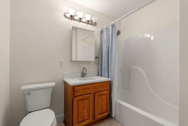 bathroom featuring shower / bath combination with curtain, vanity, toilet, and tile patterned floors