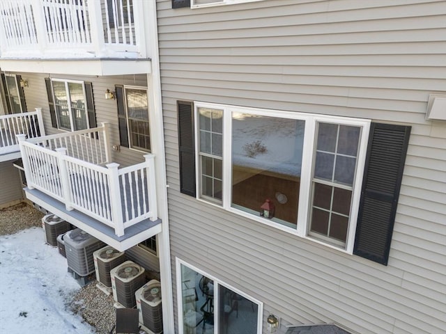 view of snowy exterior featuring central AC