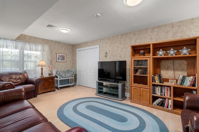 living area with visible vents and light wood finished floors