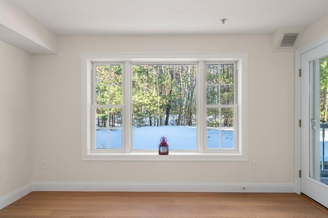 interior space with light wood-type flooring, visible vents, and plenty of natural light