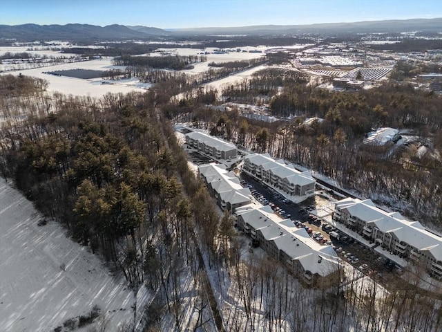 snowy aerial view with a mountain view