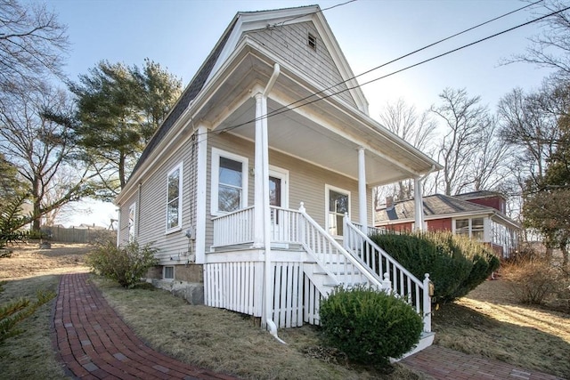 view of front of house featuring stairway and covered porch