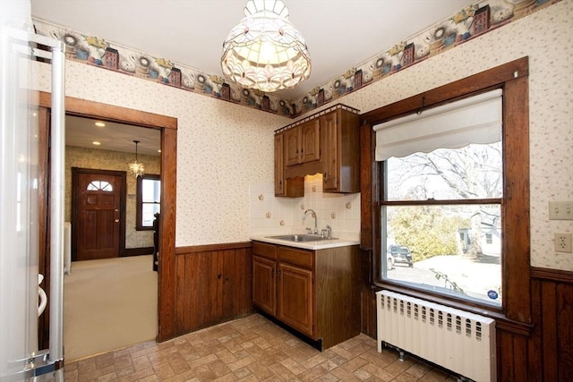 kitchen with wainscoting, wallpapered walls, and radiator heating unit