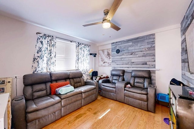 living room featuring ceiling fan and light wood-style flooring