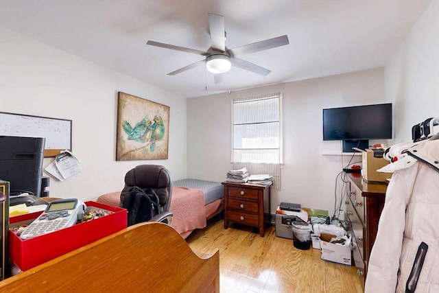 bedroom with wood finished floors and a ceiling fan