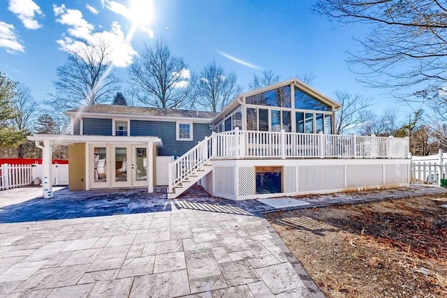 rear view of house featuring stairs, a deck, and fence