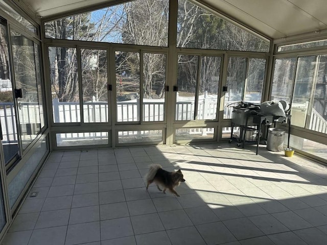 unfurnished sunroom with lofted ceiling and plenty of natural light