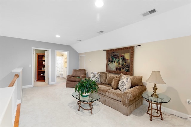 carpeted living room with vaulted ceiling