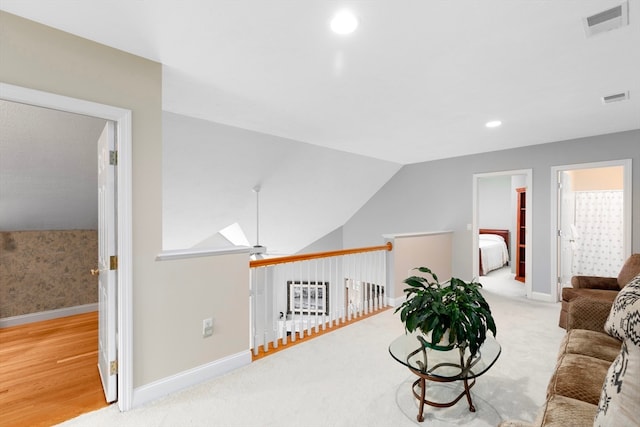 living room featuring light hardwood / wood-style flooring, lofted ceiling with skylight, and ceiling fan