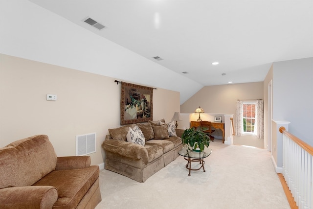 carpeted living room featuring vaulted ceiling