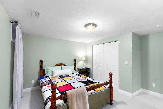 bedroom featuring light carpet and a closet