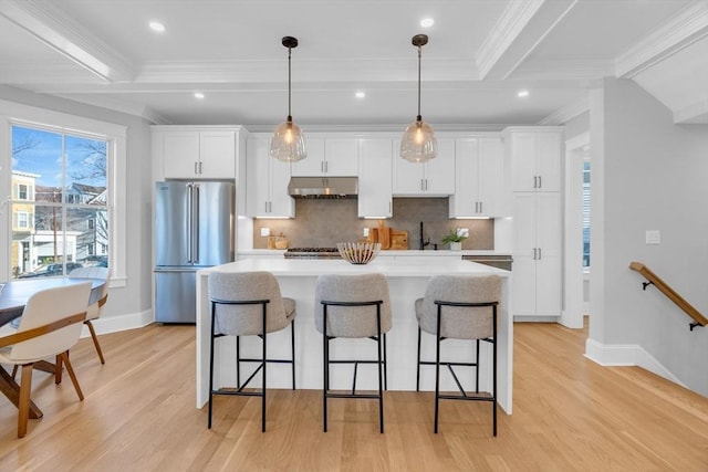 kitchen featuring beam ceiling, white cabinetry, high end refrigerator, and a kitchen island with sink