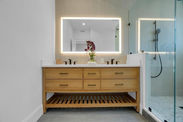 bathroom with an enclosed shower, vanity, and tile patterned flooring