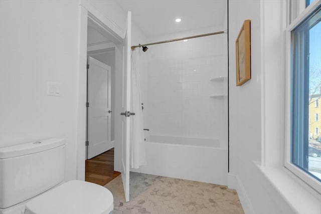 bathroom featuring toilet, shower / bathing tub combination, and tile patterned floors