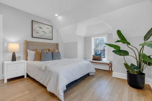 bedroom featuring lofted ceiling and light hardwood / wood-style floors