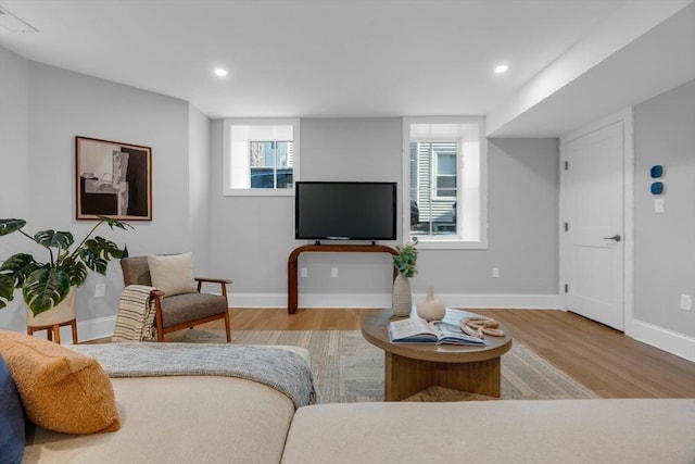 living room with a wealth of natural light and light hardwood / wood-style floors