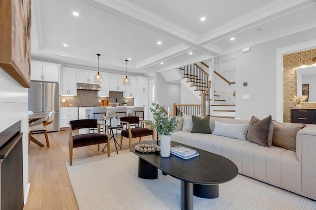 living room featuring light wood-type flooring, beamed ceiling, and crown molding