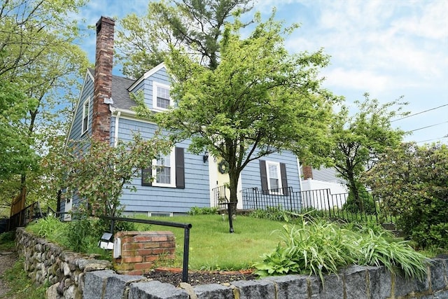 view of property exterior featuring fence and a chimney