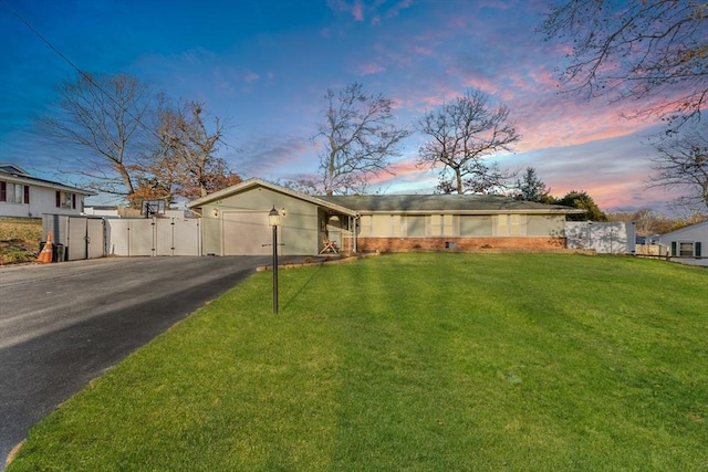 ranch-style home with a lawn and a garage