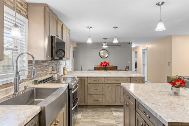 kitchen with decorative backsplash, sink, and hanging light fixtures