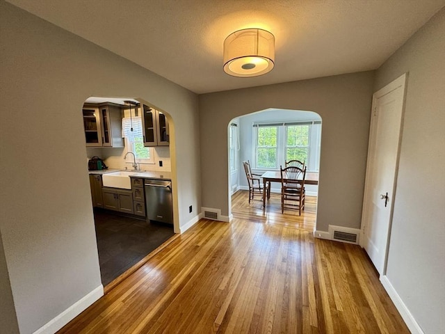 167 Pleasant St, East Longmeadow, MA 01028 - dining space with arched walkways, dark wood finished floors, and baseboards