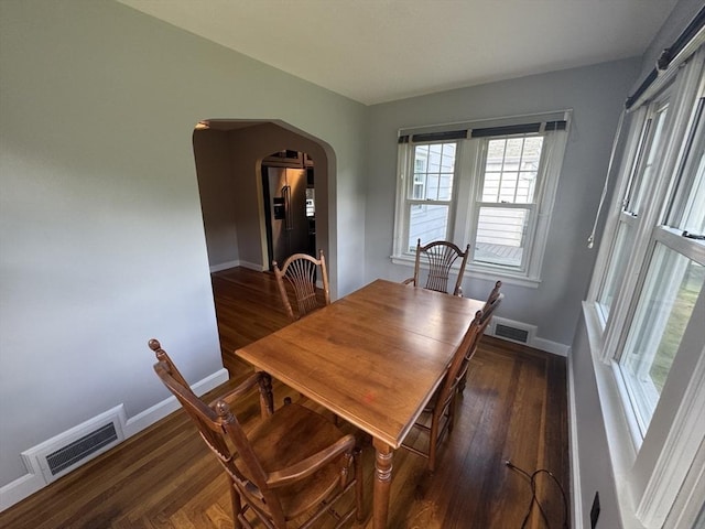 167 Pleasant St, East Longmeadow, MA 01028 - dining space with arched walkways, wood finished floors, and baseboards