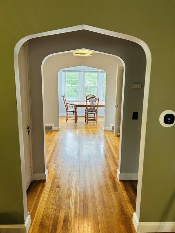 167 Pleasant St, East Longmeadow, MA 01028 - hallway with arched walkways, wood finished floors, and baseboards