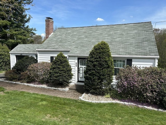 167 Pleasant St, East Longmeadow, MA 01028 - view of front of property featuring a garage, a chimney, and a front yard