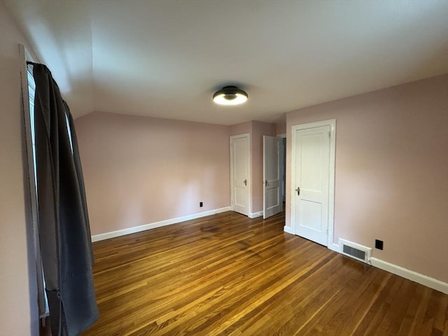 167 Pleasant St, East Longmeadow, MA 01028 - empty room featuring dark wood-type flooring, baseboards, and vaulted ceiling