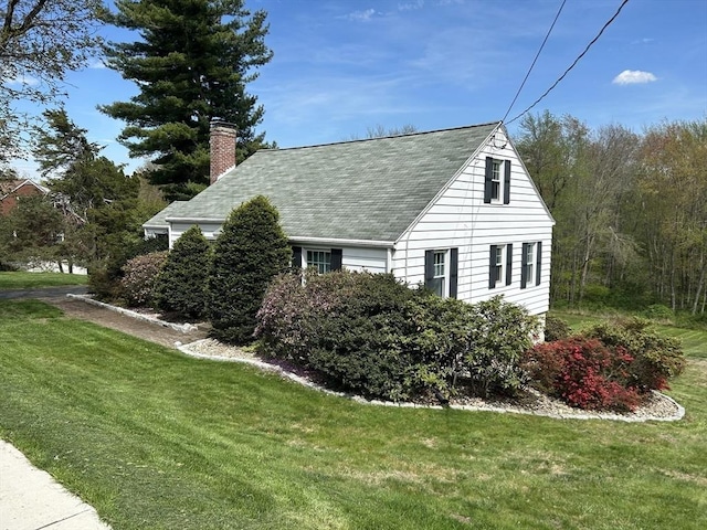 167 Pleasant St, East Longmeadow, MA 01028 - view of home's exterior with a chimney, roof with shingles, and a lawn