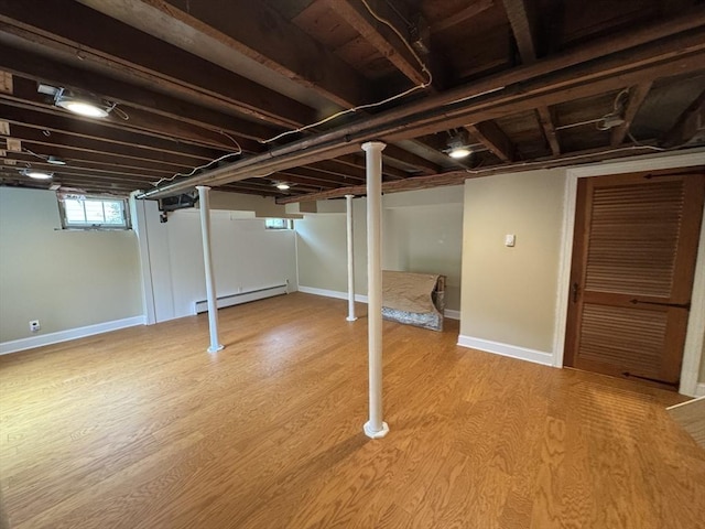 167 Pleasant St, East Longmeadow, MA 01028 - basement with baseboard heating, wood finished floors, and baseboards