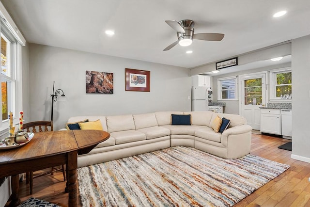 living room featuring light hardwood / wood-style floors, plenty of natural light, and ceiling fan