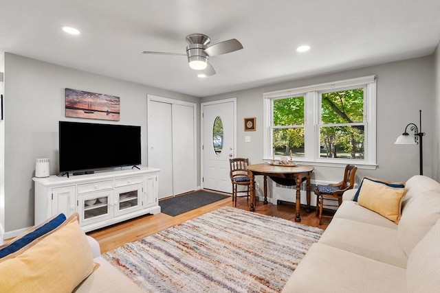 living room featuring hardwood / wood-style flooring and ceiling fan