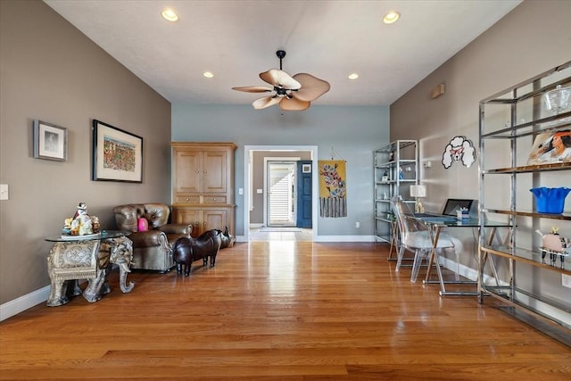 interior space featuring baseboards, a ceiling fan, wood finished floors, and recessed lighting