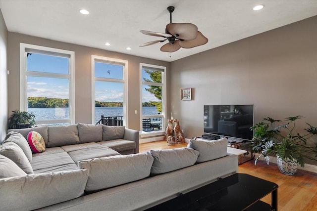 living room featuring baseboards, recessed lighting, a ceiling fan, and wood finished floors