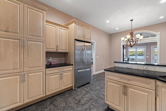 kitchen with an inviting chandelier, light brown cabinets, freestanding refrigerator, and recessed lighting