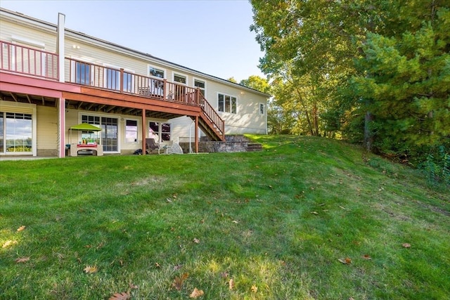 back of house featuring a yard, a deck, and stairway