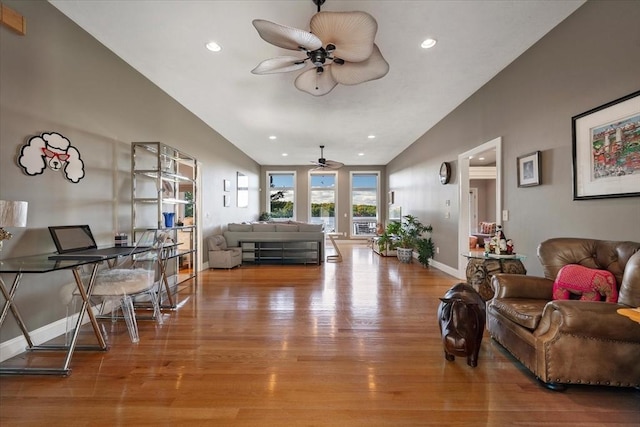 living room featuring baseboards, recessed lighting, a ceiling fan, light wood finished floors, and vaulted ceiling