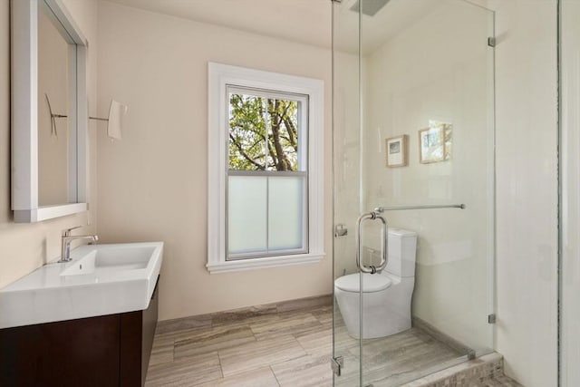 full bath featuring toilet, a shower stall, and vanity