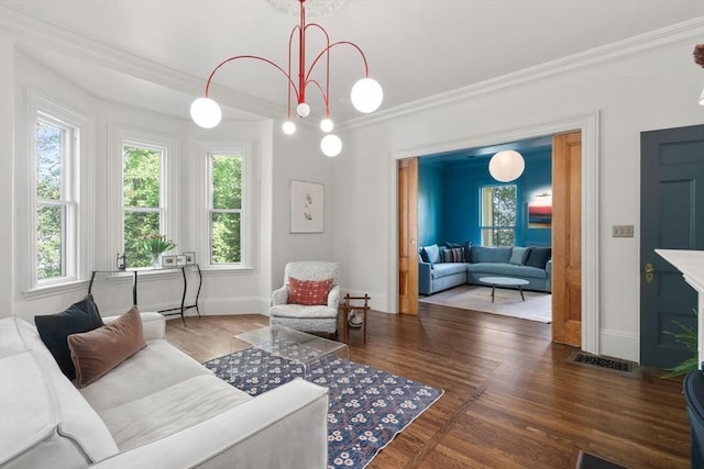 living area with crown molding, wood finished floors, and baseboards