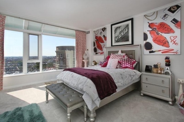 carpeted bedroom featuring multiple windows, ornamental molding, and baseboards
