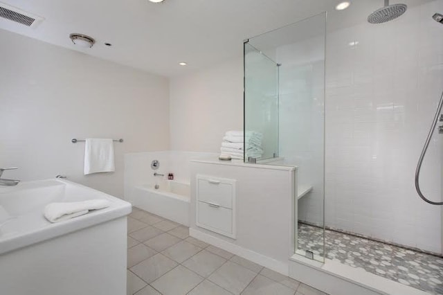 full bathroom featuring a tile shower, a garden tub, tile patterned flooring, and vanity