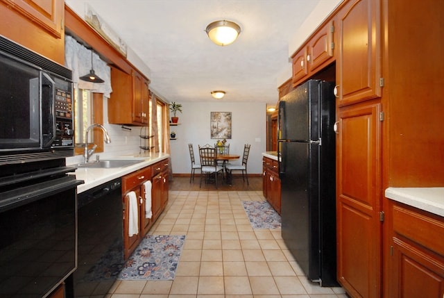 kitchen featuring black appliances, sink, decorative backsplash, decorative light fixtures, and light tile patterned flooring