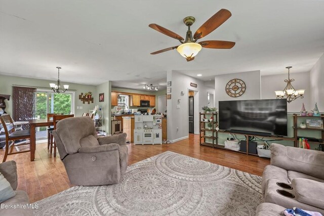32 Scott Rd, Savoy, MA 01256 - living room with a chandelier, a ceiling fan, and light wood-type flooring