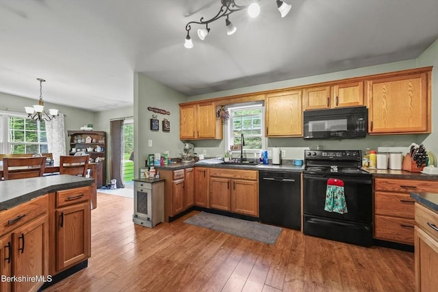32 Scott Rd, Savoy, MA 01256 - kitchen with black appliances, a chandelier, dark countertops, and healthy amount of natural light