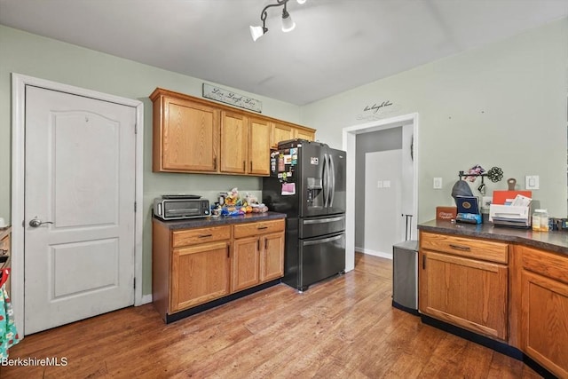 32 Scott Rd, Savoy, MA 01256 - kitchen featuring fridge with ice dispenser, dark countertops, light wood finished floors, and brown cabinets