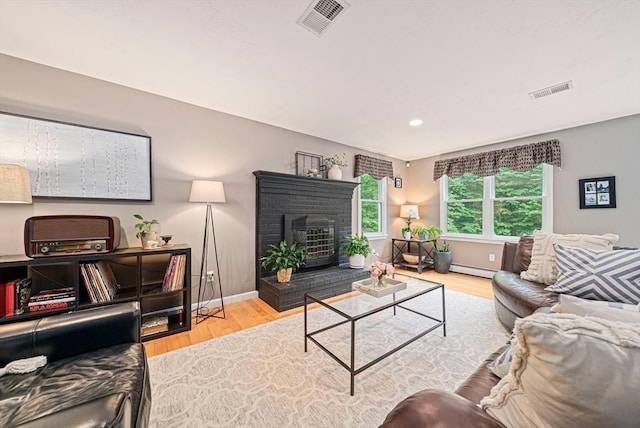 9 Captains Way E, Bridgewater, MA 02333 - living area featuring wood finished floors, a fireplace, baseboard heating, and recessed lighting