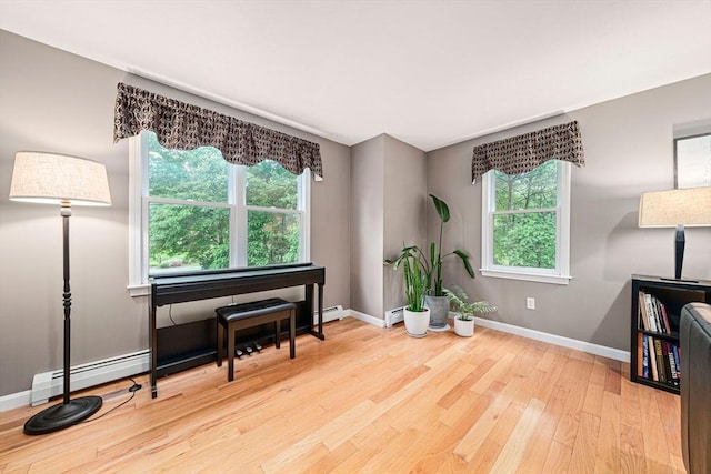 9 Captains Way E, Bridgewater, MA 02333 - sitting room with wood finished floors, plenty of natural light, and a baseboard radiator